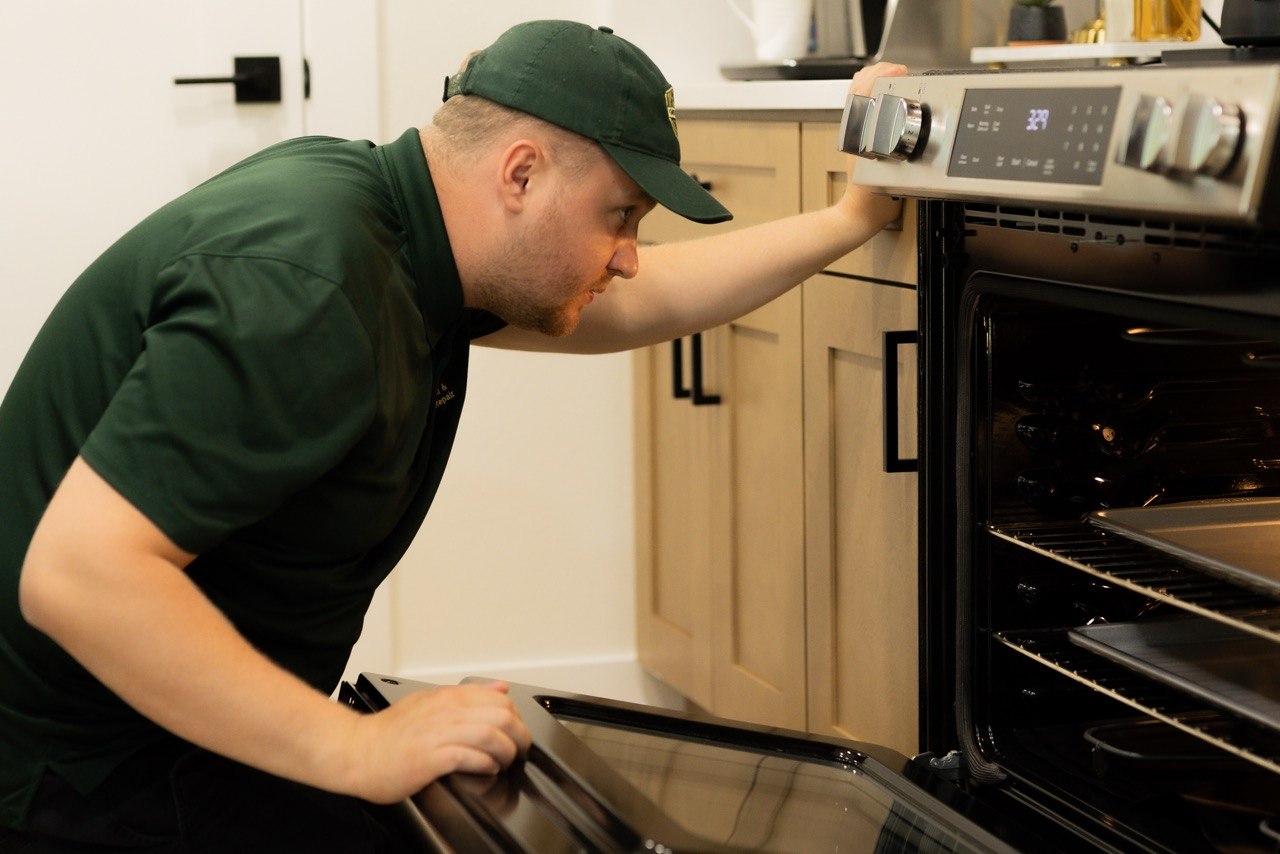 GreenFix technician repairing appliance